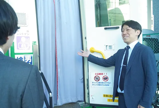 巡回健診に案内する男性　